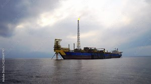 FPSO tanker with burning flare boom. Oil and gas industry production