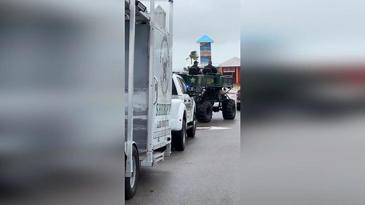 Florida police use swamp buggy to drive through floods to deliver aid