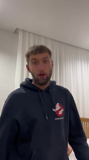 Cozy Bedroom Scene with Ghostbusters Hoodie