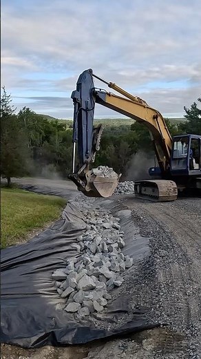 Installing rip rap rock along a driveway. #diy #ownerbuilder #homesteading #heavymachinery