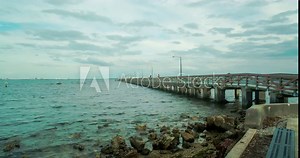 Tide coming in around fishing pier in Tampa Bay time lapse Stock Video