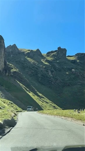 Winnats Pass is a spectacular limestone gorge in the Peak District where a narrow road winds through towering cliffs and jagged pinnacles, formed millions of years ago as a prehistoric underwater ravine and known today for the swirling "wind gates" that howl between its steep, grassy slopes. #travel #peakdistrict | UK Hidden Gems