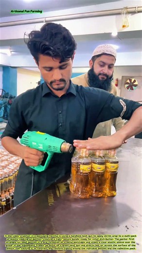 Shrink-Wrapping Cooking Oil Bottles: A Worker Using a Heat Gun to Bundle Retail Packs