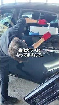 Repairing a dent in a Maserati door using paintless dent repair.