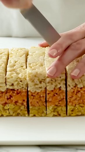 Like giant candy corn candy, these cereal treats are sure to delight—and they're fun and easy to make. You won’t want to save them for October 31st—make a batch this weekend and see how fast they go. Get the recipe: bit.ly/3PT7VOt | Martha Stewart