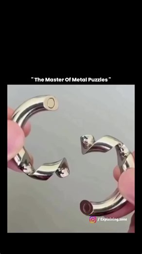 Explaining zone on Instagram: "This video showcases a precision-crafted metal disentanglement puzzle, a type of mechanical brain teaser designed to challenge spatial reasoning, patience, and problem-solving skills rather than physical strength. Such puzzles rely on carefully calculated curves, angles, and locking points, where the solution is based on alignment and sequence, not force-using force can permanently damage the polished metal or make the puzzle harder to solve. Studies in cognitive s