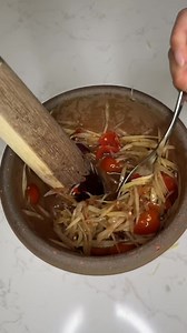 This is a Lao style papaya salad which uses fermented fish sauce called pa daek. Everyone has their own way of making it and you can add different things to it depending on what you like or what you have on hand. I’m sharing the 3 staple ingredients I use and the brands that I like. Ingredients: 3 cups shredded green papaya 1 cup Cherry tomatoes 2 tbsp sugar 4-5 Thai chili peppers 3 tbsp Pa daek - fermented fish sauce ** you can add water to dilute the saltiness 2 tbsp minced seasoned crab 1.5 t