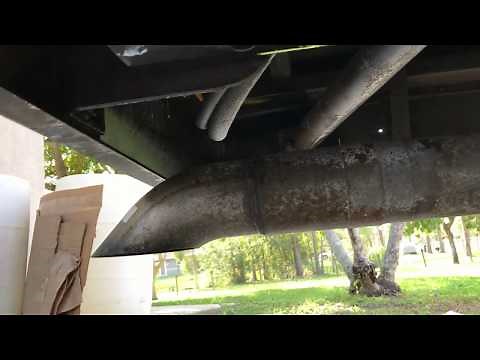 Applying Ospho rust converter under the rear of the bus