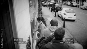 CCTV footage of people queuing to get cash from an ATM machine