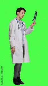 Side view Woman doctor examines x ray scan to find disease diagnosis for patient, looking at radiography results to determine illness and cure. Medic standing against greenscreen backdrop. Camera A.