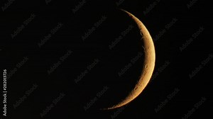 Waxing crescent moon seen with telescope in hot summer night, moon movement and air turbulence visible