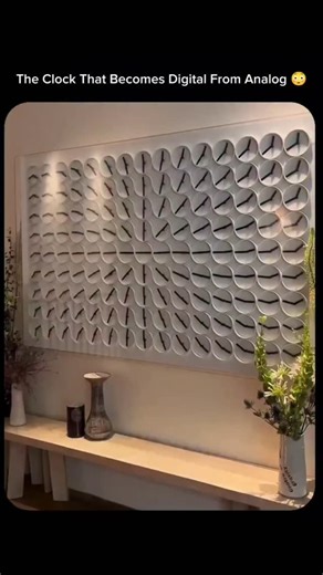 explains_.everything on Instagram: "What looks like a wall of tiny analog clocks is actually a single, mesmerizing digital timepiece. Each pair of clock hands moves in perfect harmony with the others, coming together to form the current time in a digital-style display. Between transitions, the hands dance in mesmerizing synchronized patterns — blending precision engineering, kinetic art, and minimal design. . . This installation, known as the ClockClock 24, reimagines how we perceive time — turn