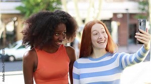 Video of multiracial friends making a video call through a smartphone, waving, gesturing, and talking in a fun conversation