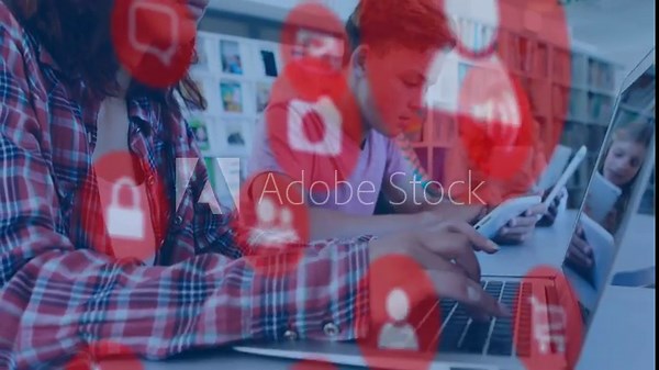 Students typing and tapping devices in library, red icons appearing over scene showing studying