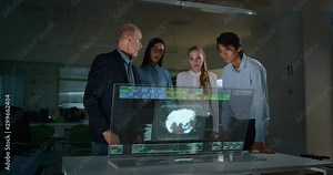 A group of designer are using a futuristic sophisticated technology screen with augmented reality holograms for a new worldwide global project realization in an office.