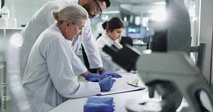 Clipboard, collaboration and science with team in lab for breakthrough, development or research. Desk, documents and innovation with people working together for pharmaceutical discovery or solution