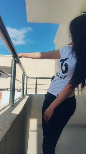 Person on Balcony Enjoying Clear Sky View