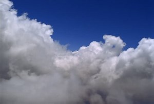Flying through white, puffy clouds