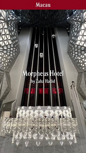 Art of Travel Japan on Instagram: "The Morpheus Hotel in Macau, completed in 2018 and designed by Zaha Hadid (@zahahadidarchitects), is the world’s first free-form exoskeleton high-rise building. Its external structure, rather than following conventional straight lines, wraps around the building in an organic, fluid pattern. This exoskeleton eliminates the need for internal columns, allowing for expansive, open interiors and a seamless flow between spaces. The innovative design pushes the bounda