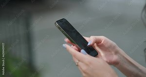 Woman using smartphone 14 pressing finger, reading social media internet, typing text or shopping online, Mobile phone in two hands at home or work close up.