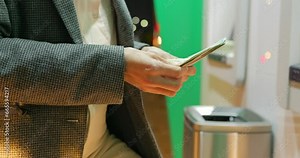 Woman hands with USD dollar near atm machine at night. Girl withdrawing money