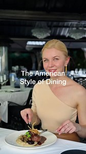 🔔 The American Style of Dining.The American style of dining differs significantly from the English style, particularly when it comes to using utensils for meals that require cutting, like a steak. In the American style, the fork and knife are often switched between hands. Here's how it's done:* Hold the knife in your dominant hand and the fork in your non-dominant hand.* Cut a piece of steak with your knife.* After cutting, place the knife along the top edge of your plate.* Switch the fork to y
