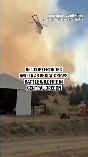 Helicopter drops water as aerial crews battle wildfire in Central Oregon