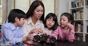 Teacher and student work on a programable robot at school science class project. Technology and Education concept. Stock Video