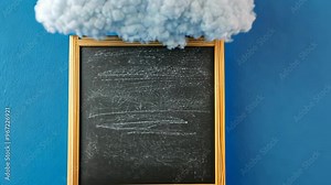 Creative chalkboard with a cloud backdrop in a bright blue setting for educational presentations or artistic expression Stock Video
