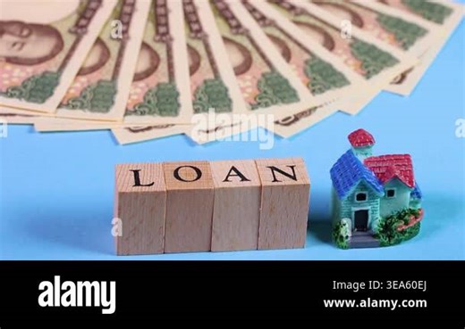 Japanese 10,000 yen banknotes, a miniature house and letter blocks spelling LOAN, rotating. The kanji characters on the banknotes meaning Bank of Japan note Stock Video Footage - Alamy