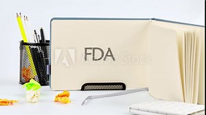 Animation of the FDA text on a blank piece of notepad. Food and Drug Administration ( FDA ) Department Service Medical Concept.