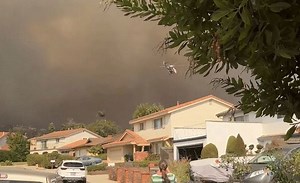 Dark Wildfire Smoke Looms Over Camarillo Neighborhood as Residents Prepare to Evacuate