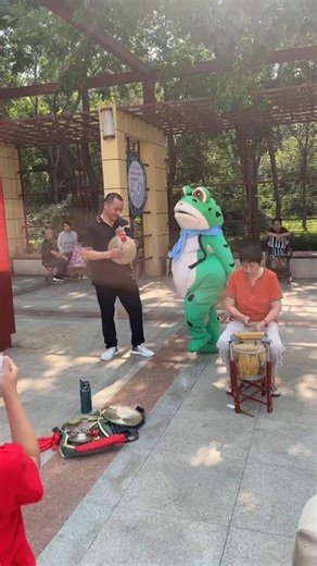 Creative Ideas on Instagram: "A person in a frog mascot costume is dancing around, pulling off hilarious moves and goofy antics, spreading joy and laughter to everyone around. This lively performance is impossible to resist, turning an ordinary day into a memorable moment filled with smiles."