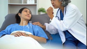 doctor talking with woman patient for monitoring and check up after surgery. doctor touching patient hand and consoling.
