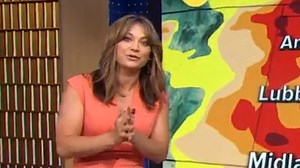 GMA's Ginger shows off fit figure in skintight orange dress on live TV