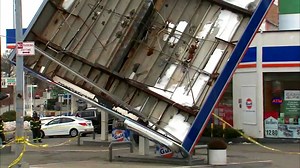 Photos: Strong winds topple gas station pumping station roof in Queens; damage throughout area