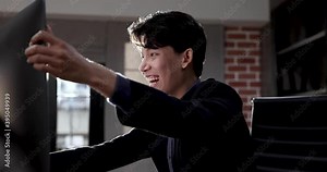Businessman was excited and overjoyed as he stared at the computer screen.