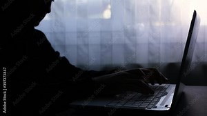 A man who opens the laptop and then works on it. Write a message. Dark image, counterpoint. Haker