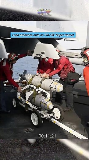 U.S. Sailors load ordnance onto an F/A-18E Super Hornet on the USS George H.W. Bush