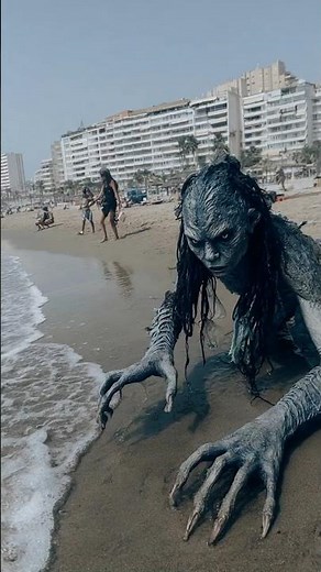Terrified Tourists Watch Mermaid Crawl Onto Spanish Shore