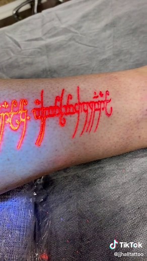 Lord of the rings tattoo done using orange UV ink, which looks like normal pigment in daylight then glows up crazy under black light (or when wearing the ring that they all froth over) 💍 ⚡️ IG: jjhalltattoo #jjhalltattoo #uvealism #lordoftherings #lordoftheringstiktok #lotr #lotrtok #uvtattoo #uvtattooink #uvtatt #uvtattoos #uvinktattoo #uvink #glowtattoo #invisibletattoo #wow #huh #cooltattoo #cooltattoos #ultraviolet #blacklighttattoo #uvレジン #uvartist #uvtattooartist