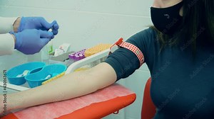 Laboratory in clinic for healthcare. Female lab assistant taking venous blood for test. HIV Hepatitis or coronavirus Test. Medicines research concept and defeating dangerous covid-19 infection