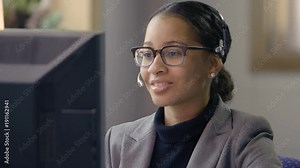 Customer service representative wearing headset talking to client