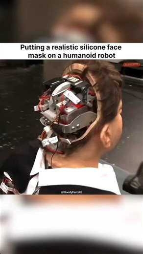 Putting a realistic silicone face mask on a humanoid robot