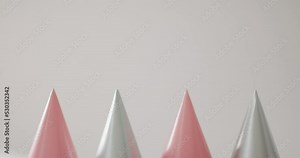 Video of a row of pink and silver party hats on pale grey background