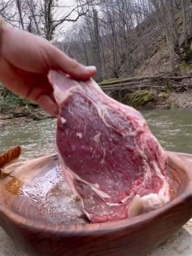 Beef Ribeye Steak Cooking Over Campfire