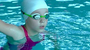 clip-1036032725-teenager-girl-goggles-looking-camera-swimming-pool