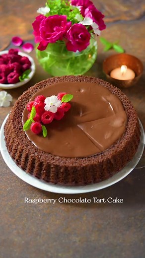 Raspberry Chocolate Tart Cake... (Recipe on @pabrecipes) Colours, flavours and textures come together to create this indulgent tart cake that looks good and tastes even better! This is where two of my favourite types of desserts meet - a cake baked in a tart tin and a tart which is a cake! It's fun to fill the indent with different fruit and you can see more ways to do it if you go down my feed. The one bowl, wholewheat eggless sponge is my go to recipe. It's super simple and works every time, l