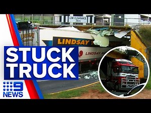 Truck trapped under low-lying bridge | 9 News Australia