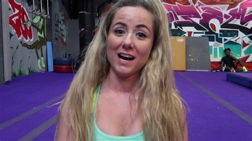 Gymnast practices difficult tumbling pass at large Brooklyn gym